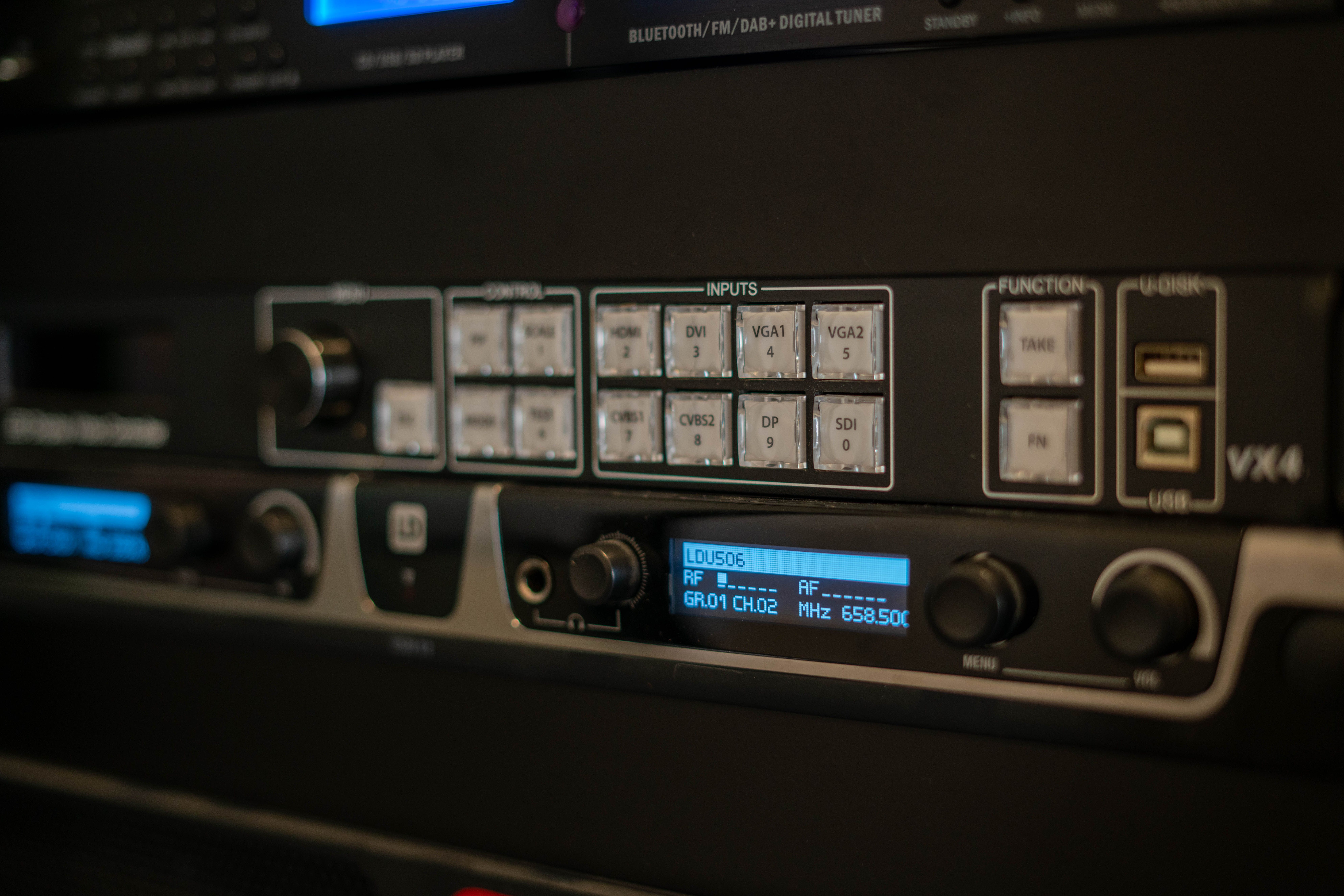 Detailed view of audio equipment showing inputs and digital controls in a studio setting.