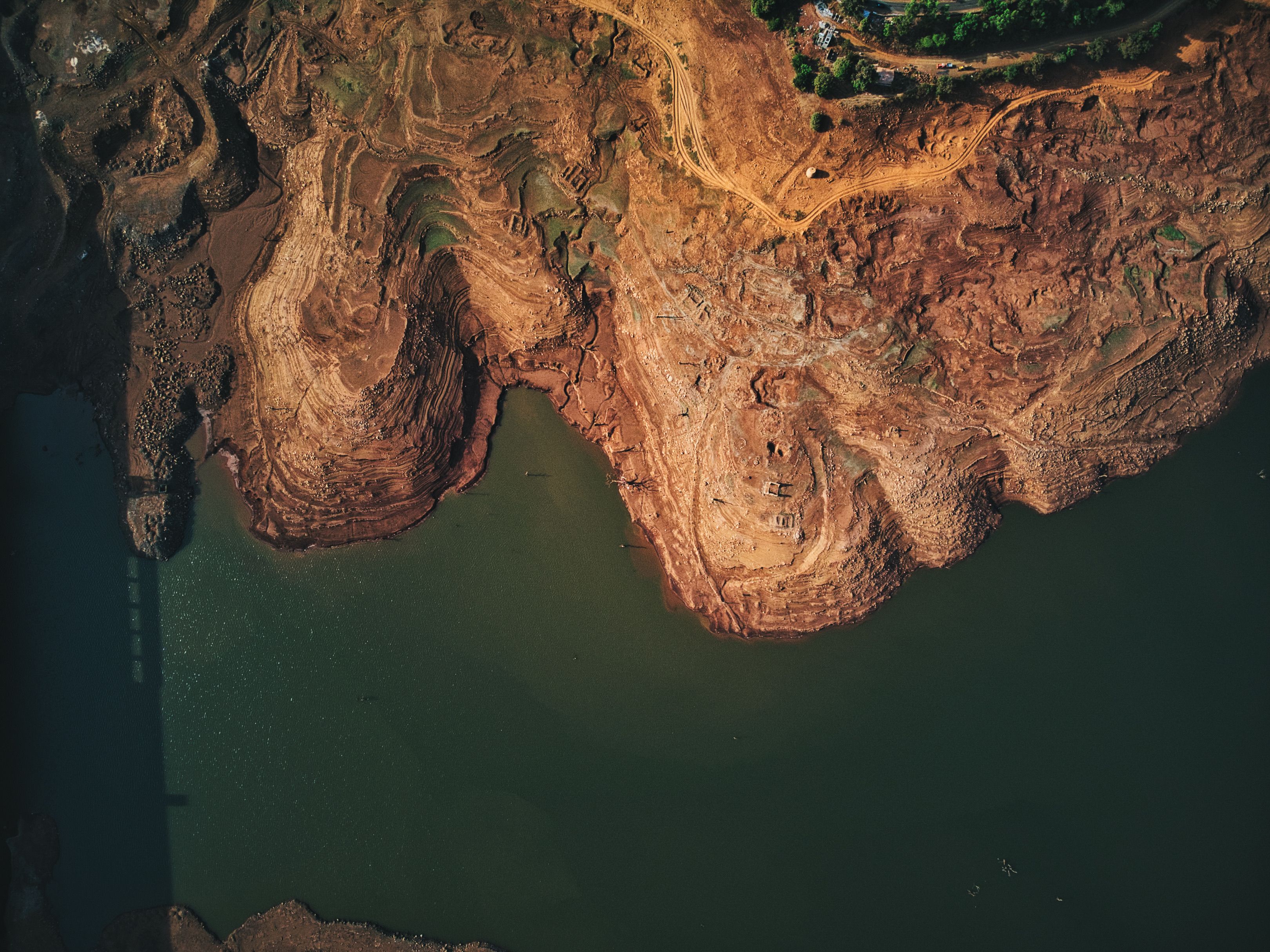 Stunning drone shot of a canyon landscape with river and rocky formations in MH, India.