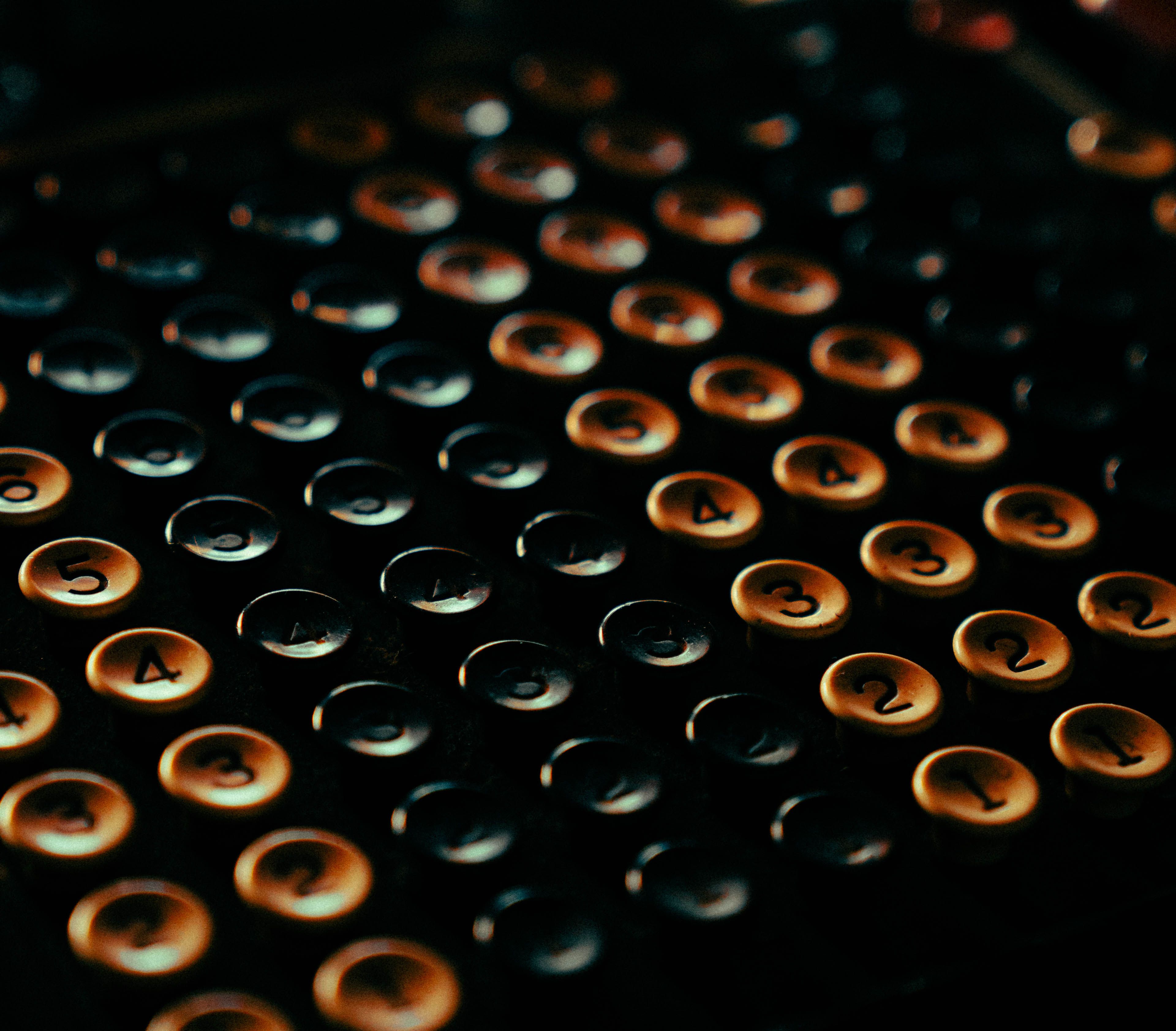 Close-up of vintage typewriter keys, showcasing a retro aesthetic and rich colors.