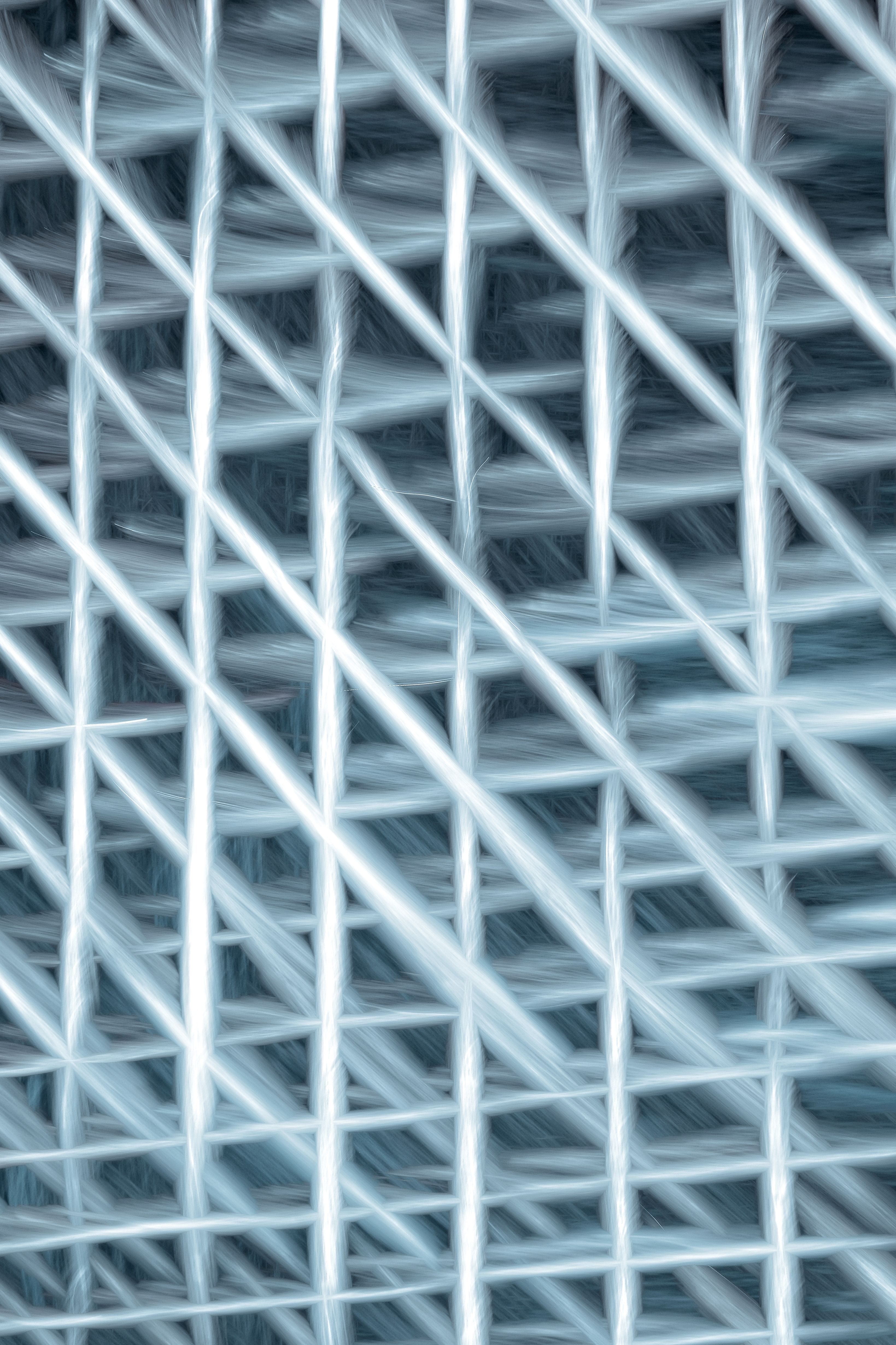 Abstract image featuring a complex diagonal weave pattern with a futuristic and metallic feel.