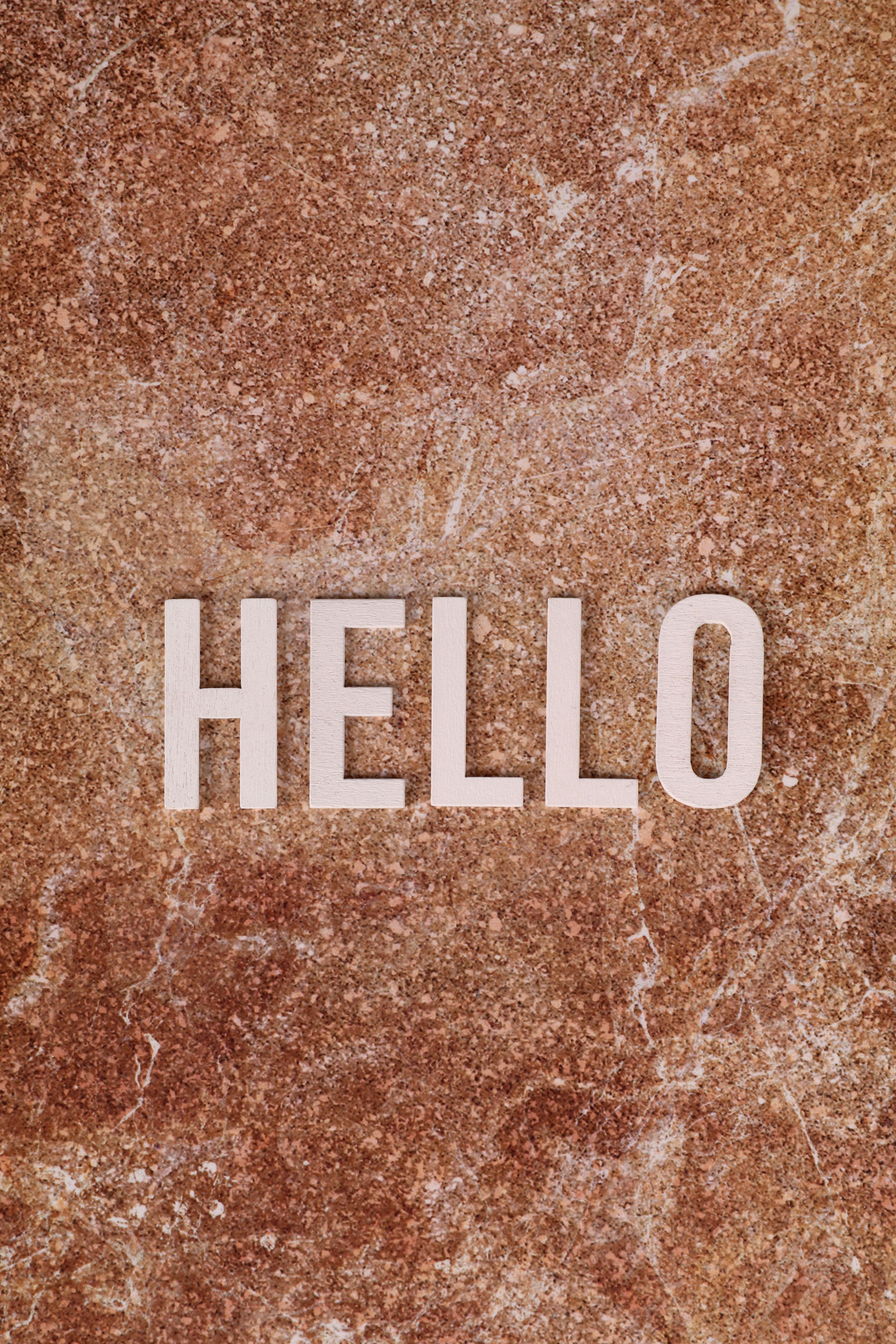 Text 'Hello' on a textured stone surface, ideal for greeting concepts.