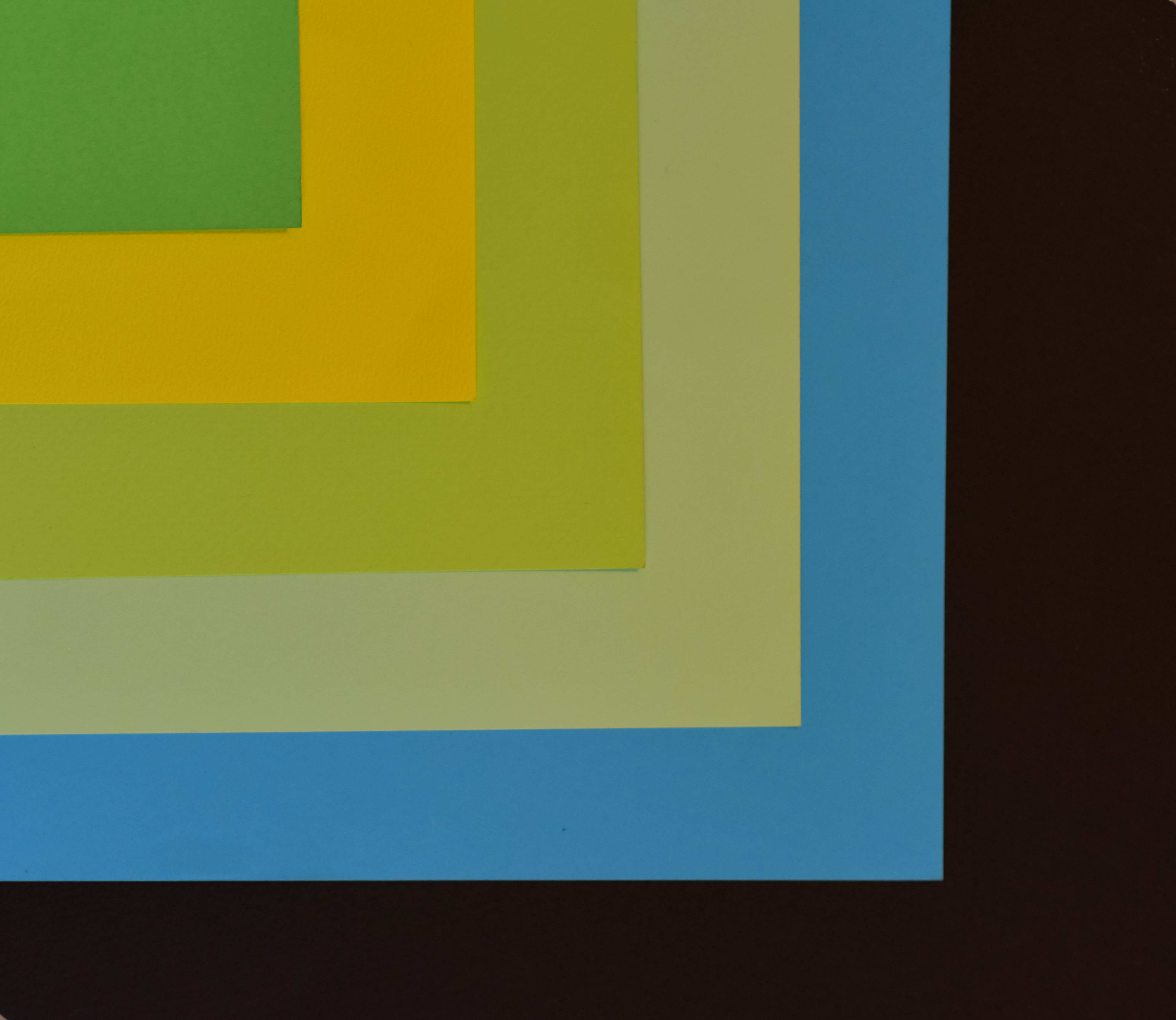 Abstract composition with colorful layered paper creating a geometric pattern.
