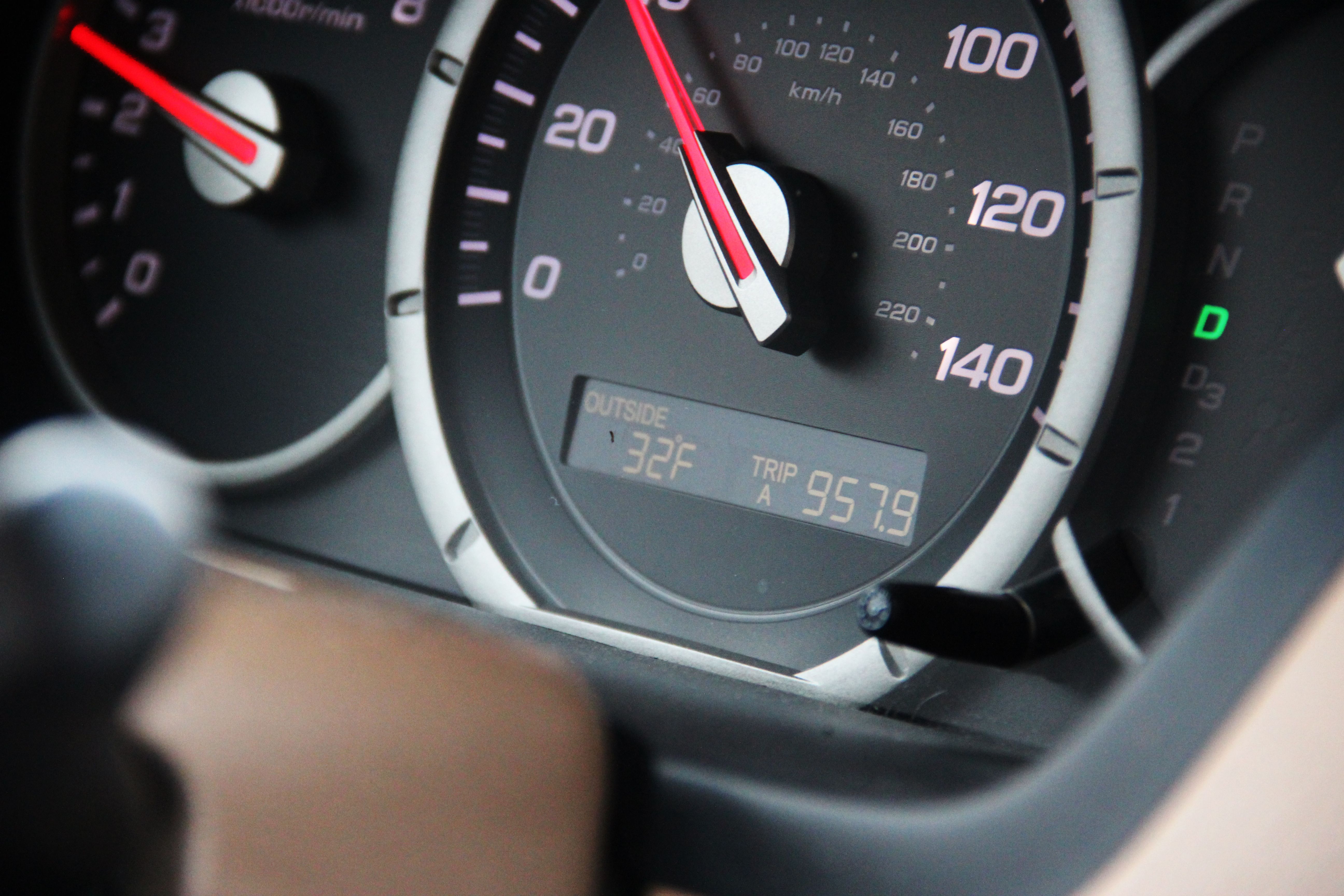 Detailed view of a car's speedometer, odometer, and temperature display showing 32°F.