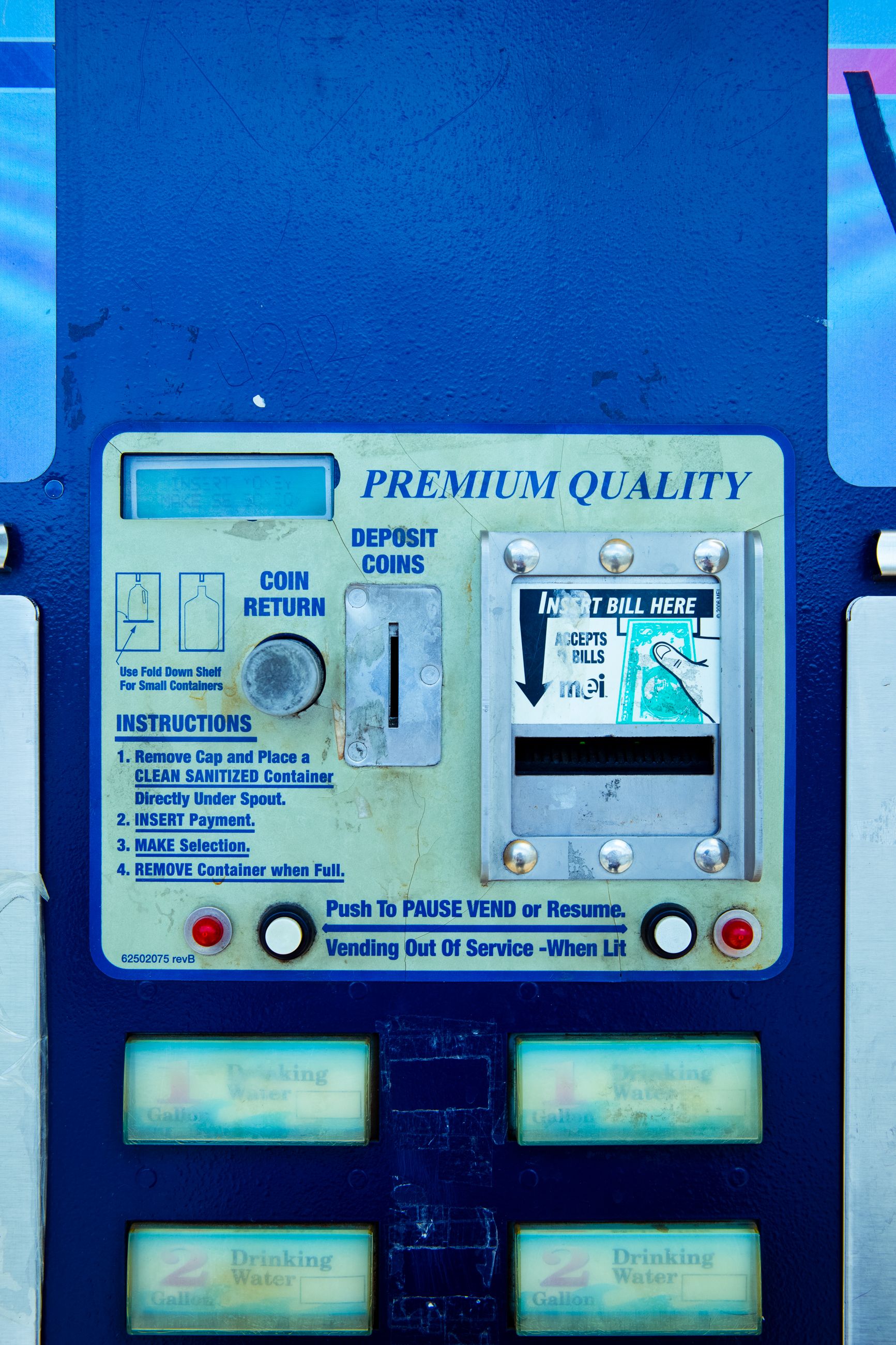 Close-up view of a vending machine coin and bill insert station with visible instructions.